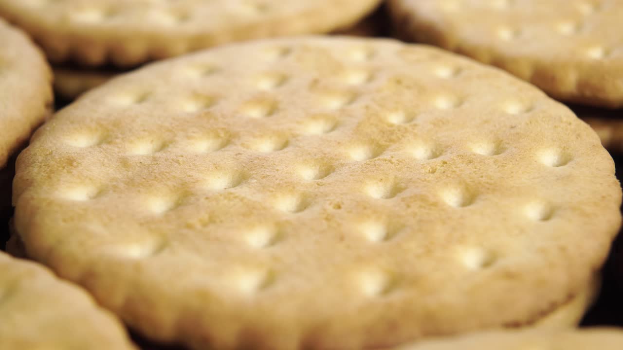 Round shortbread biscuits with dotted pattern stacked in rows