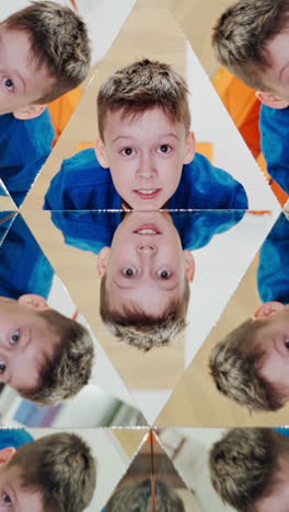 curious boy in blue and yellow shirt reflecting in the mirrors of kaleidoscope. abstract montage of a child in many triangle parts of the kaleidoscope. vertical video