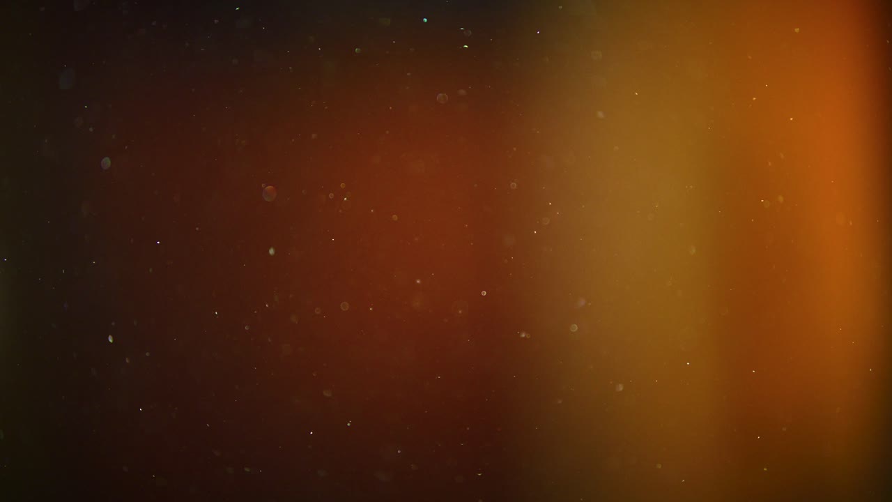 Dust Particles Drifting Gently, Soft Orange Background Slow Motion 4K