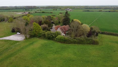 a church in the middle of green fields