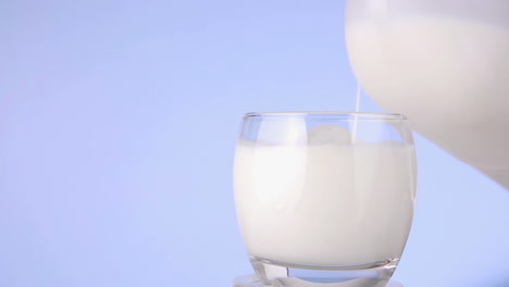 leche siendo vertida de una botella de plástico a un vaso