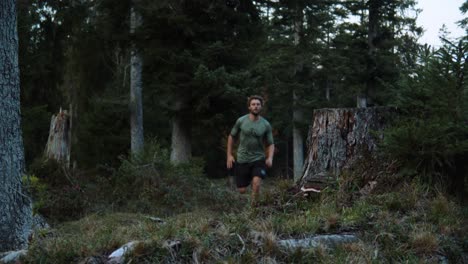 Full-shot-of-a-man-running-in-the-forest-in-the-Chiemgauer-Alpen