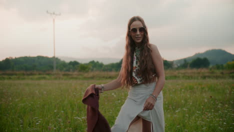 a smiling and happy woman walks among the fields