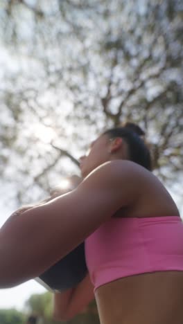 woman exercising with kettlebell outdoors