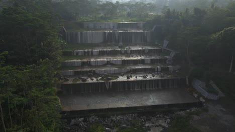 Aerial-view-of-Watu-Waterfall-during-Beautiful-sunrise-in-jungle-of-Indonesia,-Asia