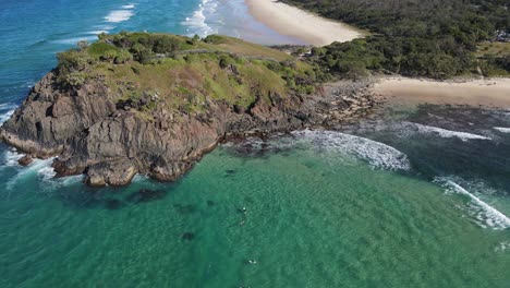 scenery of rocky cliff of norries headland and turquoise water of norries cove in new south wales, australia