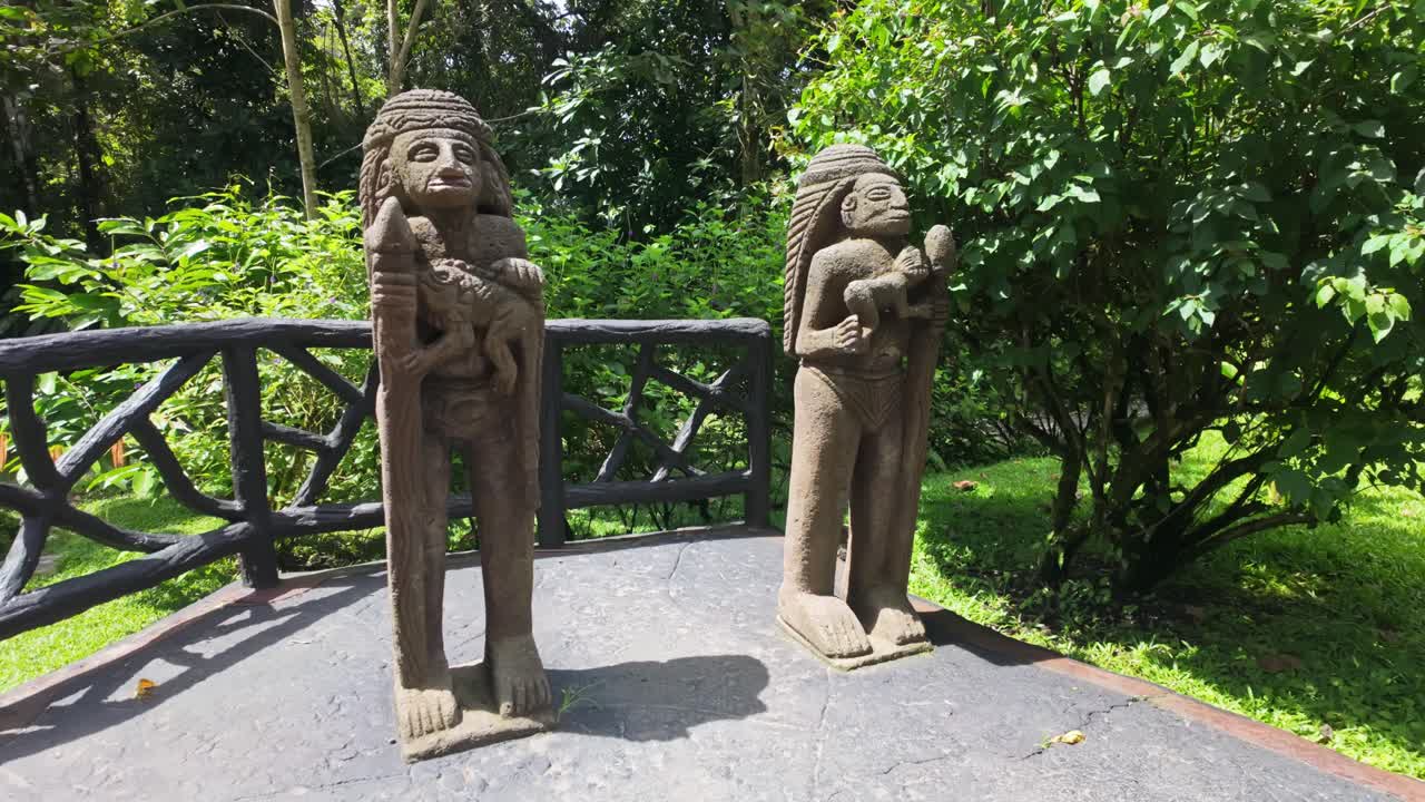 Pre-Columbian indigenous figures in a tropical cultural garden in the Mistico Park, Costa Rica