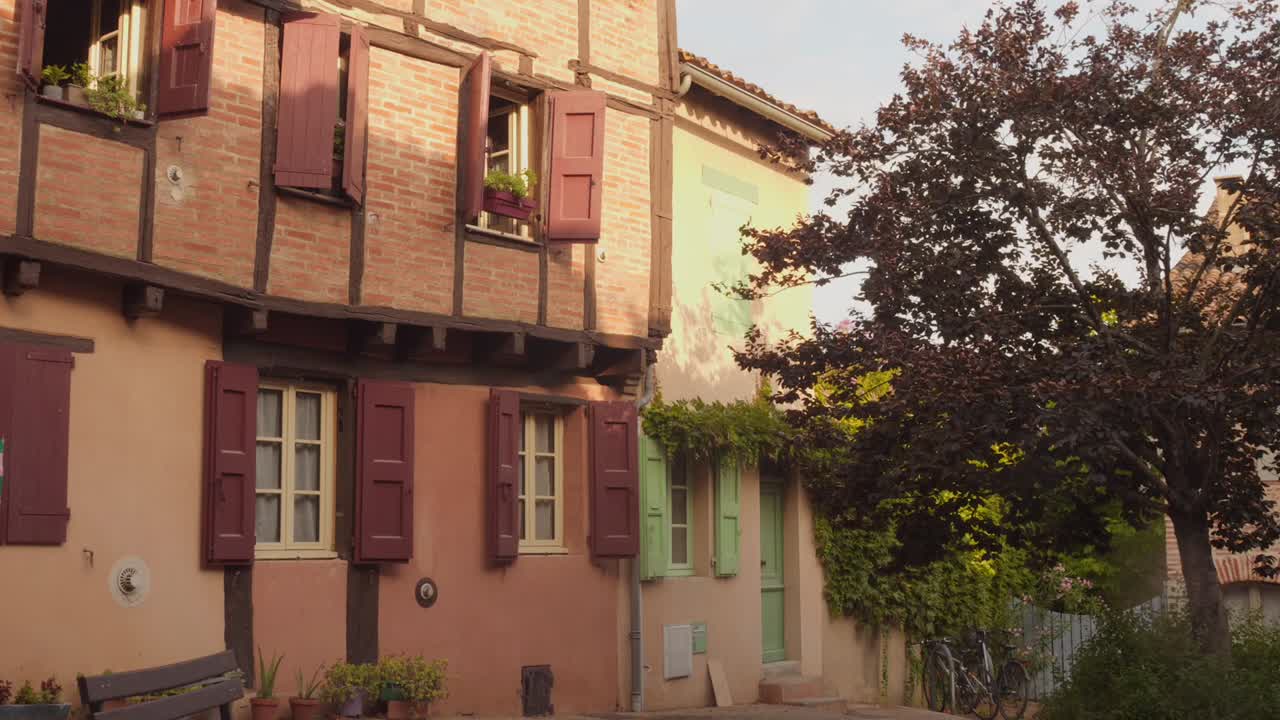 Charming old building in sunny Albi, France, with classic wooden shutters