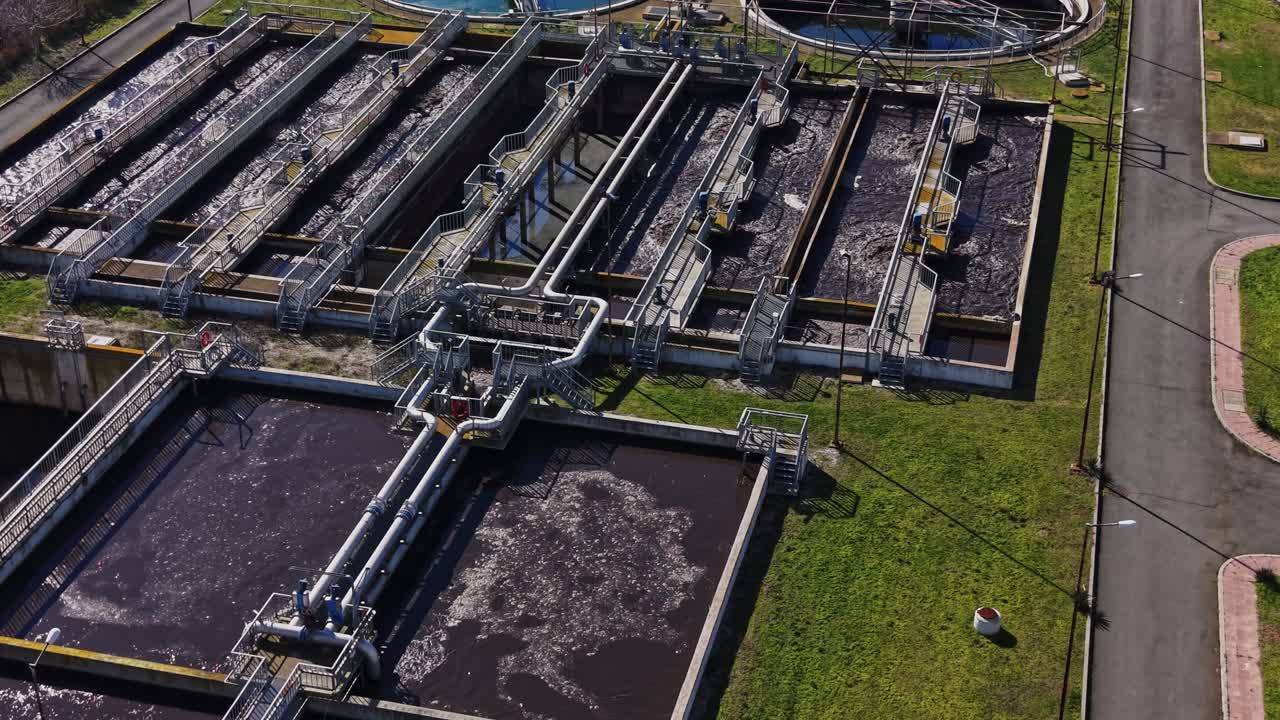 Wastewater treatment facility operates in sunny weather with clear skies