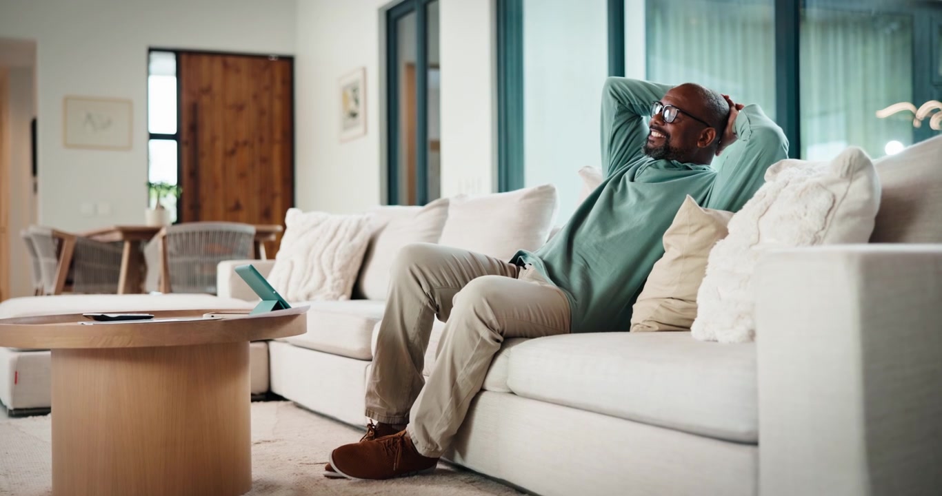 Mature Man Relaxing on Sofa After Finishing Work