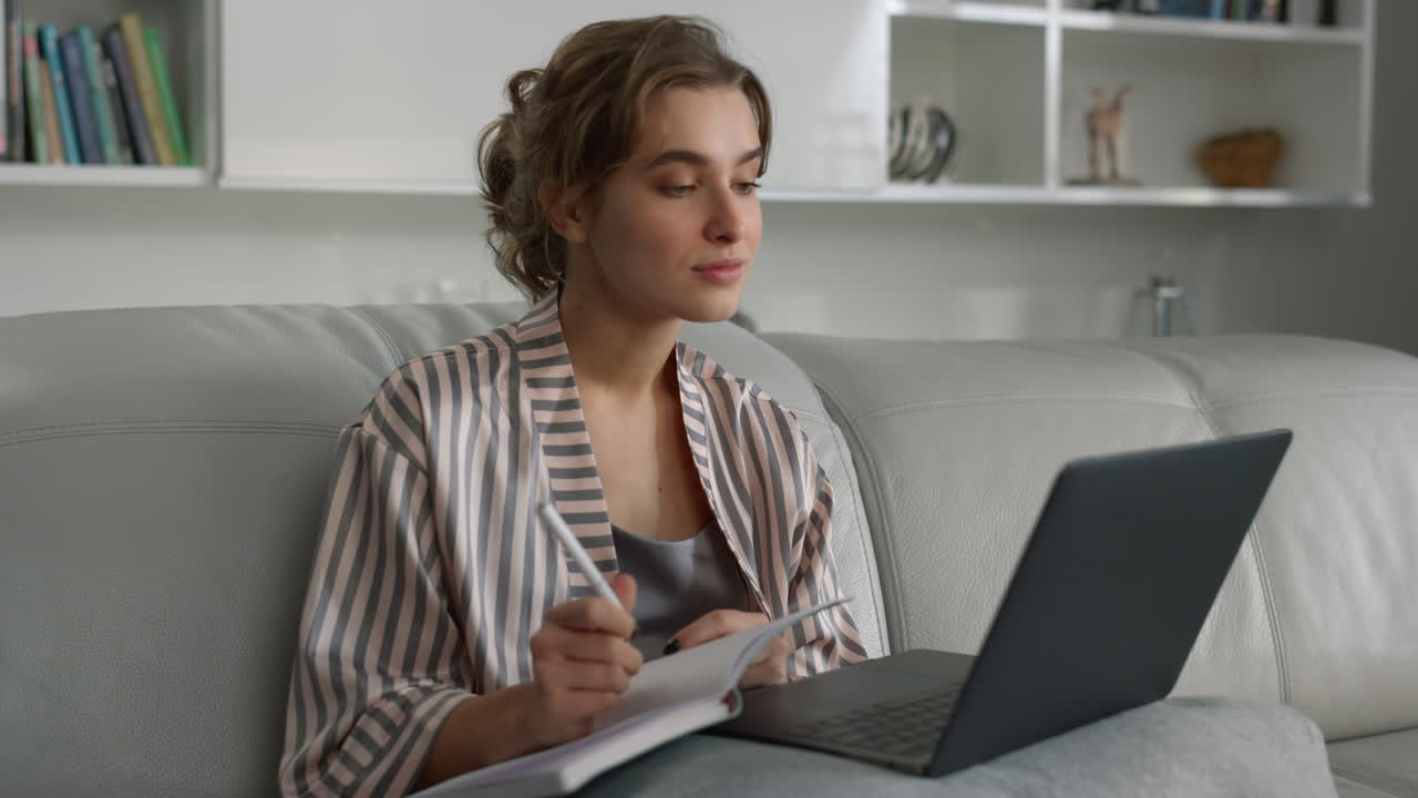 Manager watching online training in pajamas closeup. Weekend leisure at home