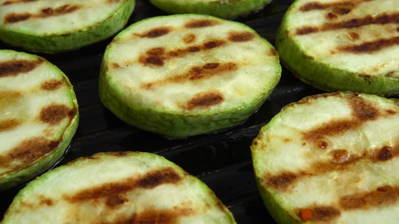 긴 zucchini 조각은 그릴 팬에 회전합니다.