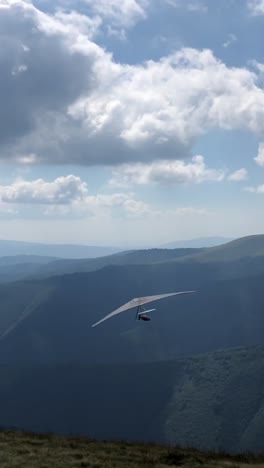 experience the thrill of hang gliding high above a breathtaking scenic mountain landscape experience the exhilarating thrill of hang gliding soaring high amidst breathtaking mountain views and scenery