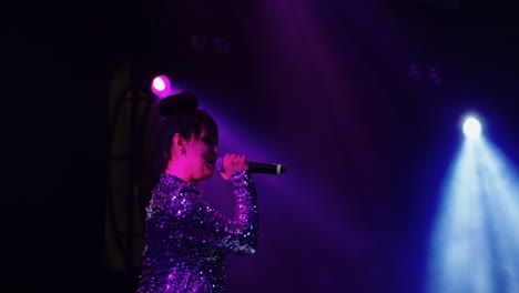 a woman singing on stage at a concert