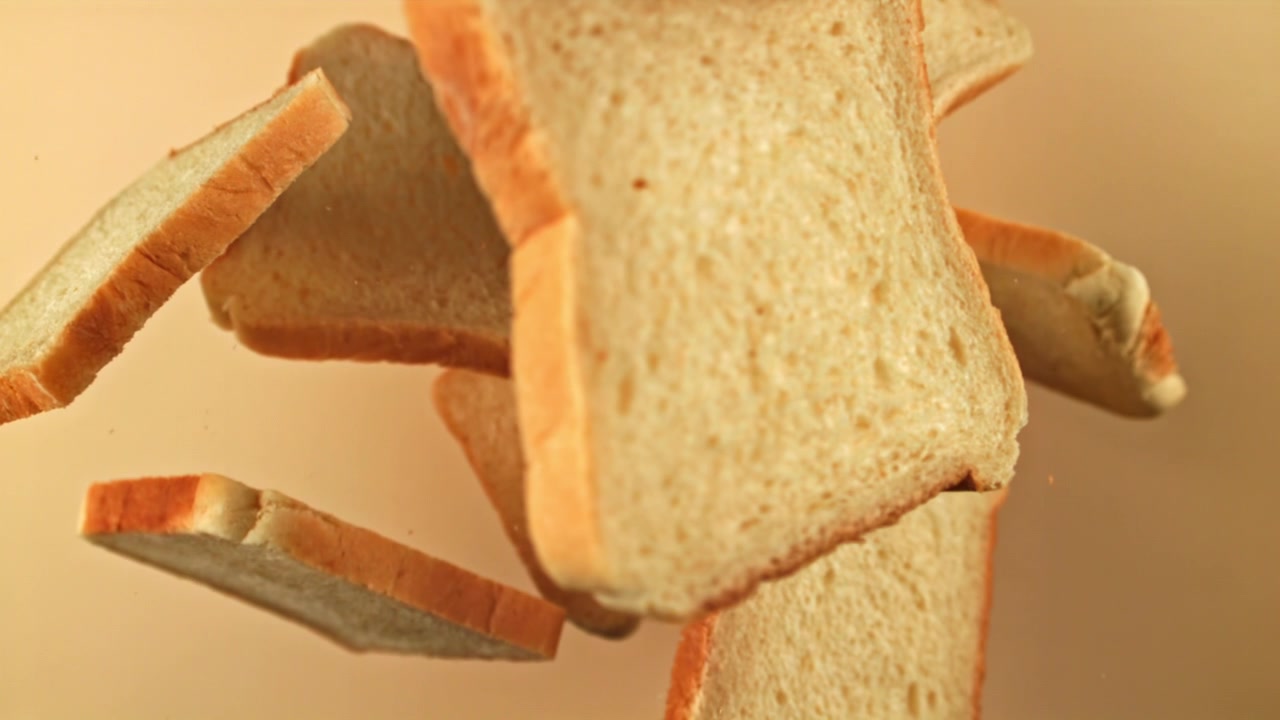 Fresh White Bread Slices Falling in Slow Motion