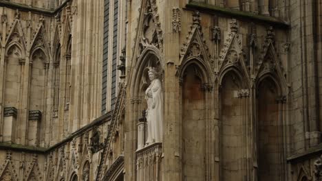 hand-held shot of a queen elizabeth statue on york minster, england