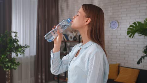 young woman drinking fresh water from a clean forest stream young woman drinking fresh water from a clean forest stream in summer pure nature peace and refreshment a quiet moment in the wilderness symbol of connection with nature and natural living