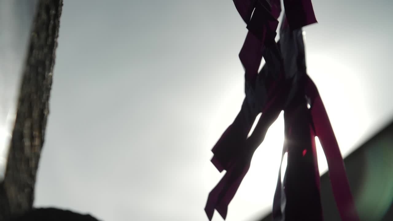 flag decoration hanging at sunset moving in slow motion at town celebration with lens flare