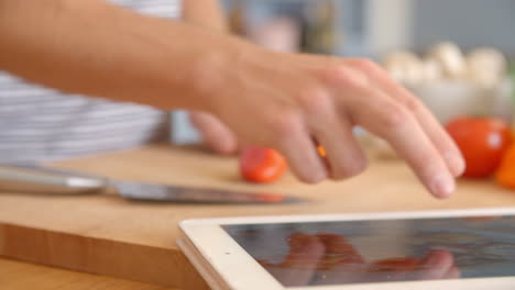 man follows recipe on digital tablet in kitchen shot on r3d