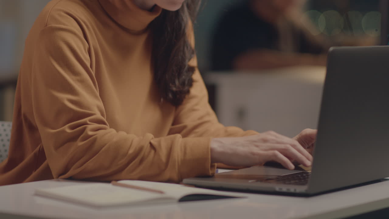 Girl Working on Laptop in Office at Night