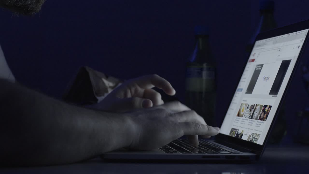 Man browsing food recipes on laptop at night