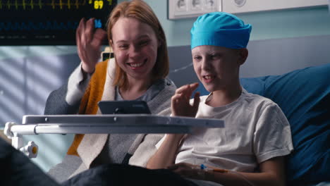 mother and child enjoying video call in hospital room
