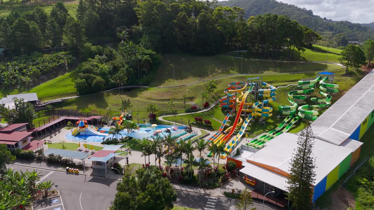 Aerial: toboggans and fun activities outdoor during the day at The Big Banana Fun Park in Coffs Harbour, New South Wales, Australia, orbit drone shot