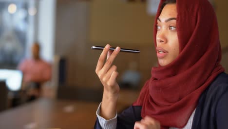 Woman-talking-on-mobile-phone-in-cafeteria-4k