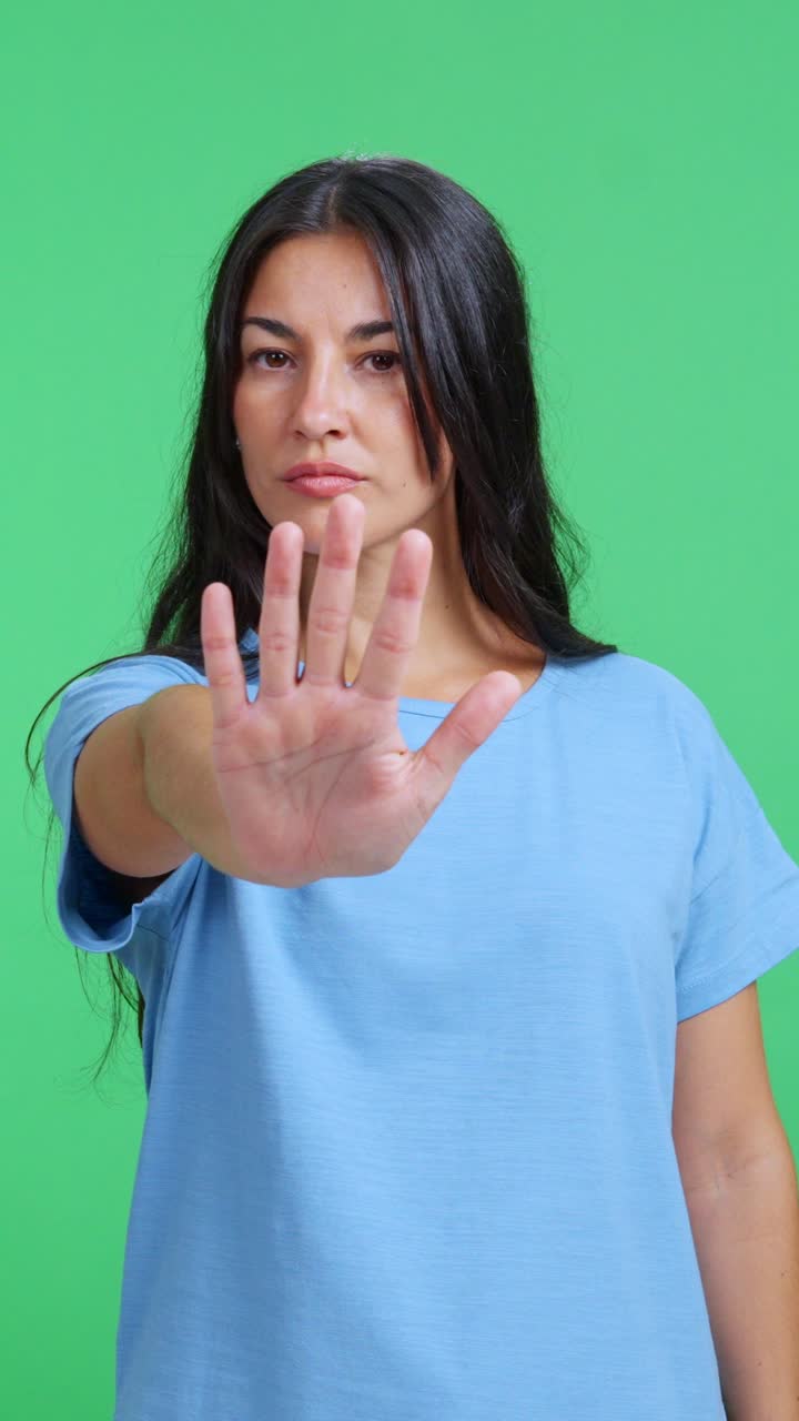 Serious woman showing a stop gesture with her hand