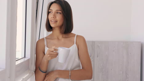 woman enjoying a coffee by the window