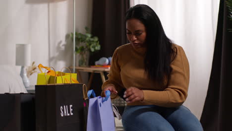 woman unpacking shopping bags at home