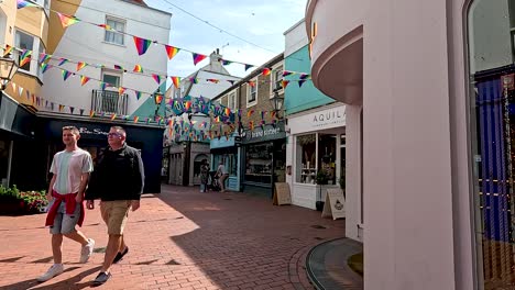 two people walking in a decorated alley