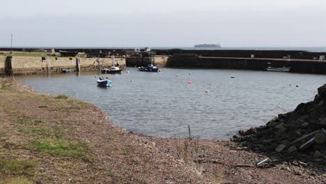 Scottish-coastal-village-harbor-with-small-boats-and-a-tanker-in-the-distance