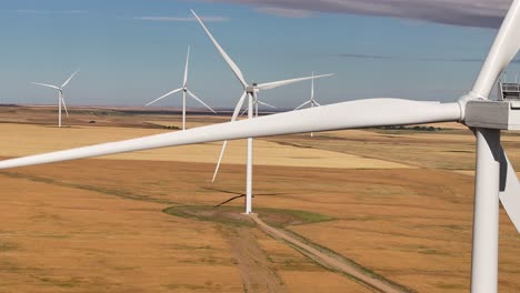 a drone flies across a prairie farmland wind farm in southern alberta, canada