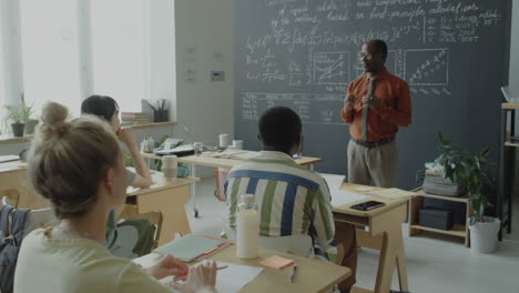 teacher lecturing students in a classroom setting
