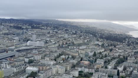 Drone-Aerial-of-the-beautiful-swiss-city-center-of-lausanne-located-on-the-lake-geneva-in-Switzerland-during-winter,-Europe