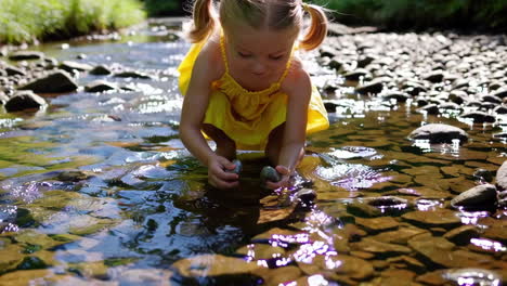 young girl playing in a rocky stream