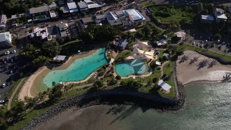 aerial view of swimming pool and waterfront resort in airlie beach, queensland, australia