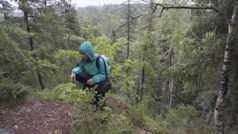 man hiking in a rainy forest