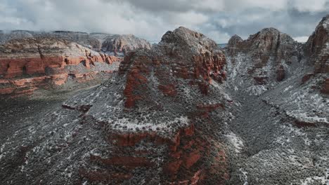 red rocks in sedona, arizona covered with snow - aerial drone shot