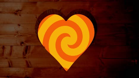 Animation-of-rotating-orange-spiral-background-over-heart-shapes-hole-in-brown-wooden-surface