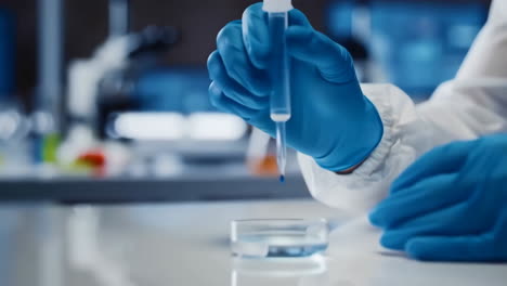 scientist's hands performing an experiment with a pipette in a laboratory