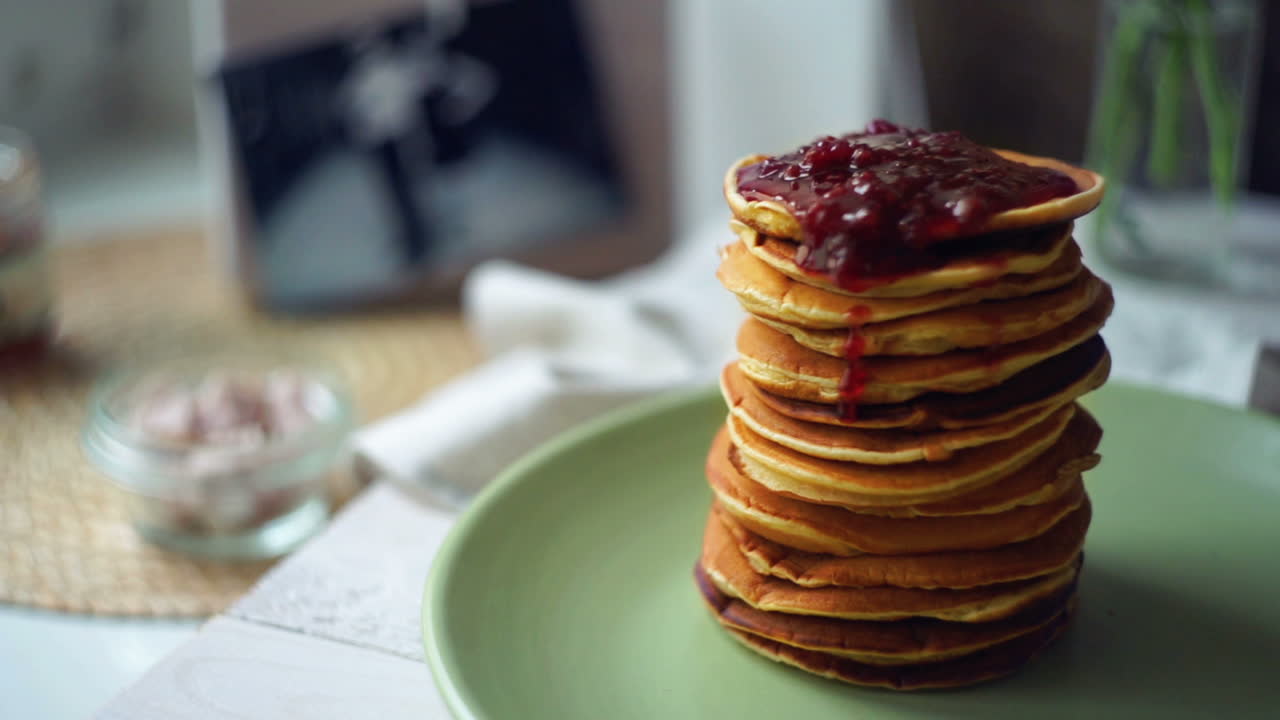 Jam on pancakes. Strawberry jam on stack of golden pancake. Sweet breakfast