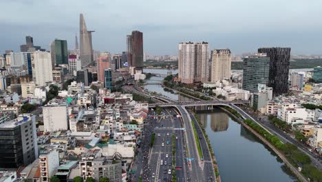 the aerial footage features the bitexco financial tower, a distinctive skyscraper in hcmc the saigon river gracefully curves through the city in the background, reflecting the fading daylight