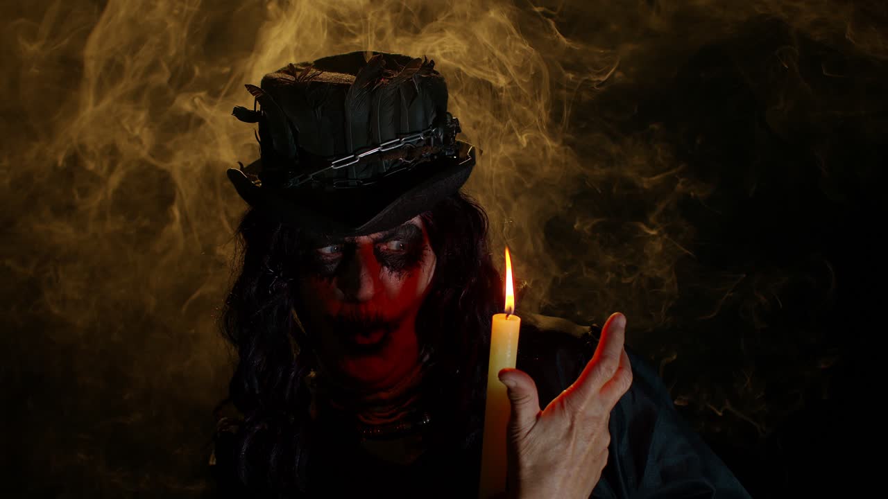 Creepy mature woman grandmother with Halloween stylish witch makeup making voodoo magic rituals