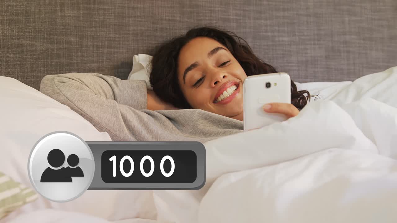 Woman lying in bed smiling while texting on her phone 4k