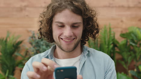 Un-Joven-Apuesto-Retrato-De-Un-Hombre-Atractivo-Sonriendo-Feliz-Enviando-Mensajes-De-Texto-Navegando-Usando-Una-Aplicación-De-Tecnología-Para-Teléfonos-Inteligentes-Disfrutando-De-La-Comunicación-Móvil