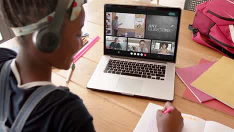 African-american-female-student-using-laptop-for-online-lesson-with-diverse-students-and-teacher