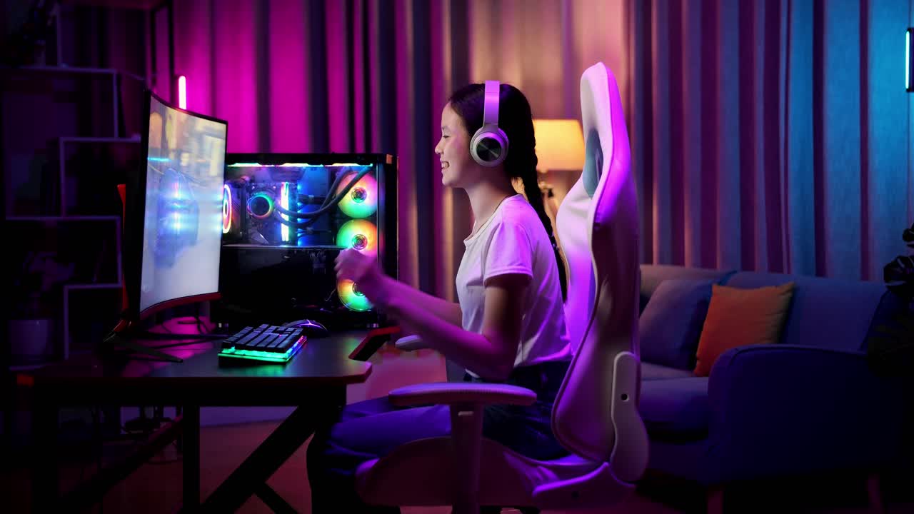 Excited Asian Teen Girl Gamer Celebrates Victory While Playing Video Game On Computer