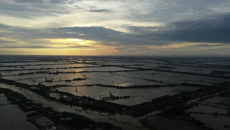 Aerial-view-of-colorful-Mekong-Delta-sunrise-over-agricultural-land-and-waterways-in-Vietnam-2